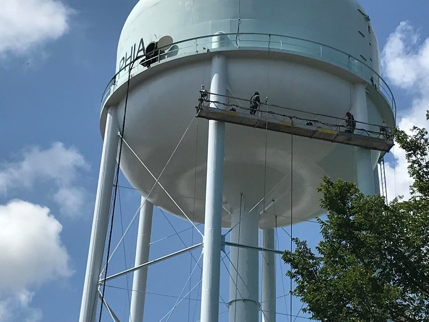 Philadelphia Utilities workers paint the Philadelphia Water tower. The work was completed this week after more than a month of work.